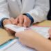 Arzt zeigt Patient medizinische Broschüre